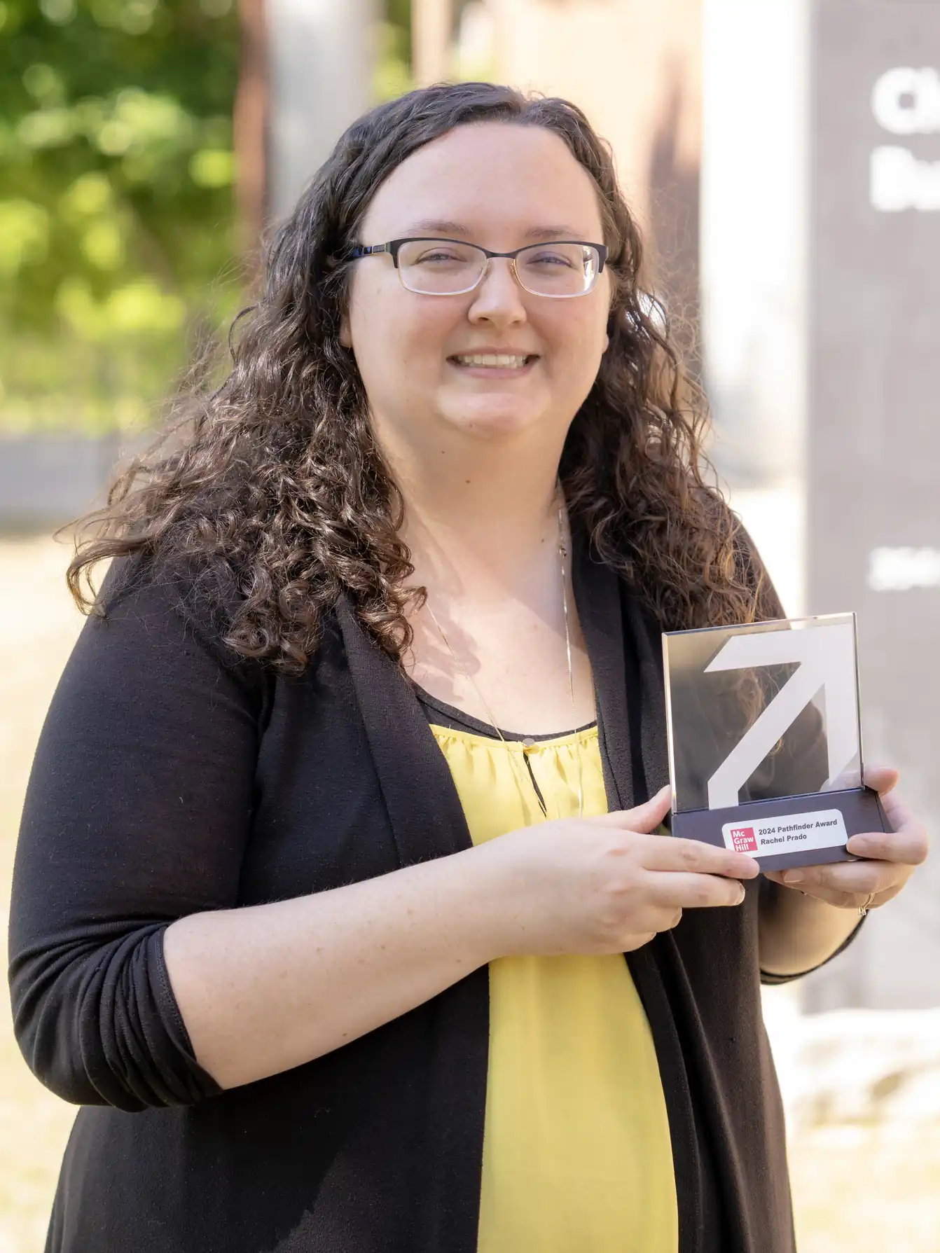 Photo of Dr. Rachel Prado holding the 2024 Pathfinder Award