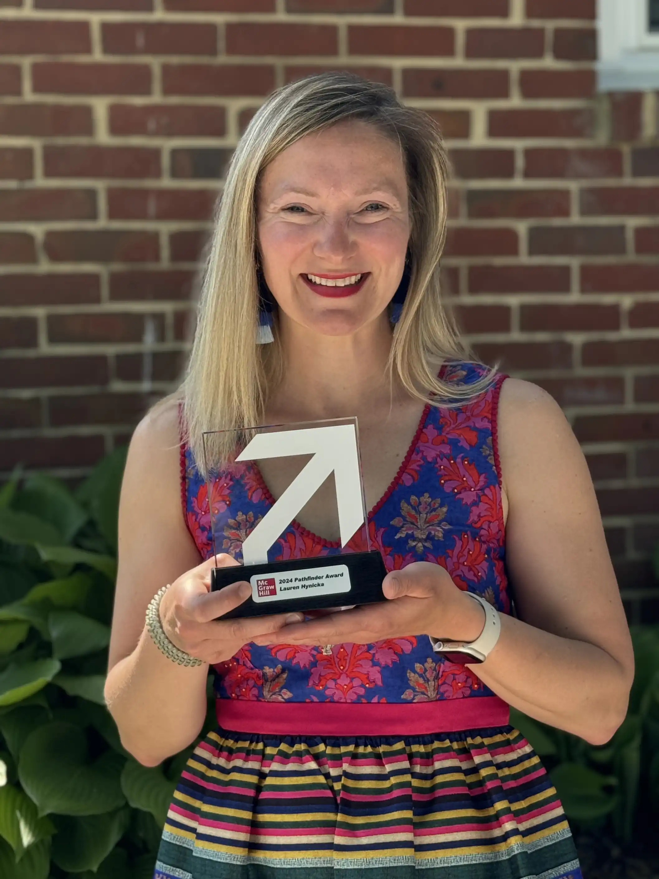 Photo of Lauren Hynicka holding the 2024 Pathfinder Award