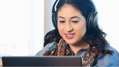 Student wearing headphones while studying