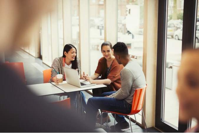 Students hanging out studying around laptop