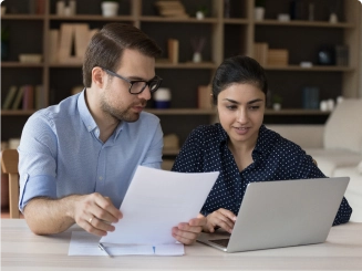 Two people working together reviewing notes