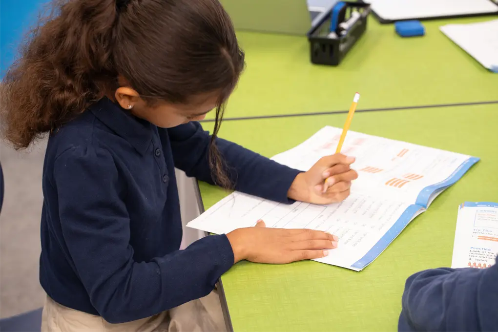 student writing in workbook