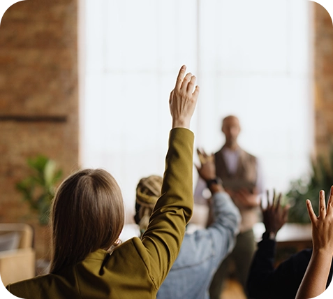 image of a woman raising her hand to ask a question